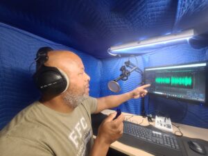 Cecil Archbold recording a voiceover session in his home studio booth
